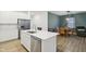 Bright kitchen features stainless steel appliances, white cabinetry and an island, transitioning into an adjacent dining area at 10008 Sundley Dr, Indianapolis, IN 46239