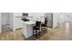 Bright, all-white kitchen features stainless steel appliances, an island with seating, and wood-look floors at 10008 Sundley Dr, Indianapolis, IN 46239