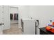 Bright laundry room with modern machines and an open doorway to a walk-in closet at 10008 Sundley Dr, Indianapolis, IN 46239
