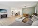 Open-concept living and kitchen area with stainless steel appliances and a breakfast bar at 10008 Sundley Dr, Indianapolis, IN 46239