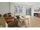 Comfortable living room featuring a sectional sofa, natural light, and modern wood-look floors at 10008 Sundley Dr, Indianapolis, IN 46239