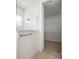 Clean bathroom showcases a tiled shower with glass enclosure and a view of a spacious walk-in closet at 15846 Vitalize Run, Fishers, IN 46040