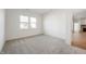 Inviting bedroom with neutral carpet, large windows, and a glimpse into the home's living spaces at 15846 Vitalize Run, Fishers, IN 46040