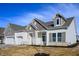 Charming home exterior with stone accents and a well-manicured lawn, showcasing inviting curb appeal at 15846 Vitalize Run, Fishers, IN 46040