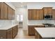 Bright kitchen with marble countertops, wood cabinets, stainless appliances, tile backsplash, and an island at 15846 Vitalize Run, Fishers, IN 46040