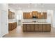 Spacious kitchen with wood cabinets, marble countertops, stainless appliances, island and tile backsplash at 15846 Vitalize Run, Fishers, IN 46040