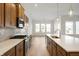 Bright kitchen featuring stainless appliances, tile backsplash, marble countertops, and an island at 15846 Vitalize Run, Fishers, IN 46040
