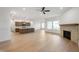 Bright, open-concept living space with a fireplace, seamlessly connecting the kitchen and living area at 15846 Vitalize Run, Fishers, IN 46040