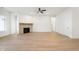 Open living area with hardwood floors and stone fireplace, providing a cozy and inviting atmosphere at 15846 Vitalize Run, Fishers, IN 46040