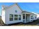 Rear exterior of home with white siding, covered patio, and multiple windows under a blue sky at 15846 Vitalize Run, Fishers, IN 46040