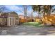 Backyard featuring a storage shed, concrete driveway, freshly cut grass, and wooden fence at 6906 Johnson Rd, Indianapolis, IN 46220