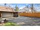 Backyard features a detached garage and partially-fenced paved driveway at 6906 Johnson Rd, Indianapolis, IN 46220