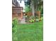Lush backyard with well-manicured lawn, stepping stone pathway, and a cozy outdoor seating area at 6906 Johnson Rd, Indianapolis, IN 46220