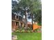 Beautifully landscaped backyard featuring mature trees, a cozy patio, and a well-maintained lawn at 6906 Johnson Rd, Indianapolis, IN 46220