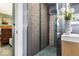 Modern bathroom with a decorative tiled shower, sleek vanity, and stylish decor elements at 6906 Johnson Rd, Indianapolis, IN 46220