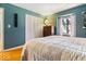 Bright bedroom with white closet doors and a window view at 6906 Johnson Rd, Indianapolis, IN 46220