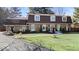 A beautifully landscaped home with a stone facade and mature trees at 6906 Johnson Rd, Indianapolis, IN 46220