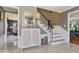 Foyer with marble flooring, decorative accents and an open staircase to the second floor at 6906 Johnson Rd, Indianapolis, IN 46220