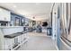 Open kitchen with white cabinets, breakfast bar, stainless steel appliances, and gray tile floors at 6906 Johnson Rd, Indianapolis, IN 46220