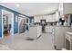 Eat-in kitchen featuring white cabinetry, stainless appliances, center island, and gray tile flooring at 6906 Johnson Rd, Indianapolis, IN 46220