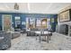 Bright living room with stone fireplace, large windows, soft carpet, and stylish, neutral decor at 6906 Johnson Rd, Indianapolis, IN 46220