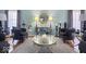 Chic living room with light-blue walls, hardwood floors and comfortable seating around a glass table at 6906 Johnson Rd, Indianapolis, IN 46220