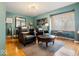 Cozy living room with hardwood floors, comfortable seating, and a bright window with blinds at 6906 Johnson Rd, Indianapolis, IN 46220