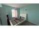 Standard bedroom featuring light blue walls, grey carpet and a window with blinds at 5325 Bluff View Dr, Indianapolis, IN 46217