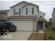 Charming two-story home featuring a two-car garage and a well-maintained lawn at 5325 Bluff View Dr, Indianapolis, IN 46217