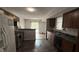 Kitchen with dark cabinets, stone counters, and a stainless range at 5325 Bluff View Dr, Indianapolis, IN 46217