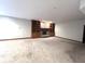 Spacious basement featuring built-in shelving, brick fireplace, and neutral carpet at 1079 Old Eagle Way, Greenwood, IN 46143