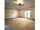 Spacious bedroom with a ceiling fan and doors leading to the backyard at 1079 Old Eagle Way, Greenwood, IN 46143