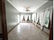 Sunroom featuring ceramic tile flooring, multiple windows with sheer curtains, and a ceiling fan at 1079 Old Eagle Way, Greenwood, IN 46143