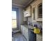 Kitchen features custom cabinets, granite countertops, black appliances, and an adjacent window at 201 W Walnut St, Waldron, IN 46182