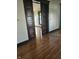 Living room showcasing beautiful hardwood floors and original dark trim sliding pocket doors at 201 W Walnut St, Waldron, IN 46182