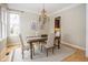 Charming dining room featuring hardwood floors, a decorative chandelier, and lots of natural light at 15571 Bridgewater Club Blvd, Carmel, IN 46033