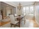 Inviting dining area featuring large windows, hardwood floors, and stylish chandelier at 15571 Bridgewater Club Blvd, Carmel, IN 46033
