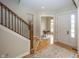 Welcoming entryway with a staircase, hardwood floors, and access to an adjacent office at 15571 Bridgewater Club Blvd, Carmel, IN 46033