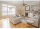 Spacious living room with ample natural light, a fireplace, and hardwood floors at 15571 Bridgewater Club Blvd, Carmel, IN 46033