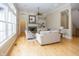 Bright living room showcases large windows, hardwood floors, fireplace, and an open layout perfect for entertaining at 15571 Bridgewater Club Blvd, Carmel, IN 46033