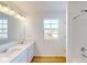 Bathroom with double sink vanity, wood floor, and natural light from window at 1833 James Pierce Dr, Shelbyville, IN 46176