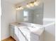 Bright bathroom featuring double vanity, large mirror, and ample lighting at 1833 James Pierce Dr, Shelbyville, IN 46176