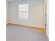 Bedroom featuring neutral carpet, white walls, and one large window at 1833 James Pierce Dr, Shelbyville, IN 46176