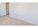 Bright bedroom featuring neutral carpet, white walls, and a white door at 1833 James Pierce Dr, Shelbyville, IN 46176
