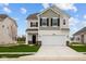 Charming two-story home featuring a gray and white color scheme, a two-car garage, and a well-manicured lawn at 1833 James Pierce Dr, Shelbyville, IN 46176