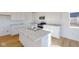 Kitchen island with marble countertops, stainless steel sink and modern appliances at 1833 James Pierce Dr, Shelbyville, IN 46176