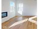 Bright living room with hardwood floors, large windows and a modern fireplace at 1833 James Pierce Dr, Shelbyville, IN 46176