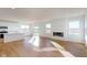 Spacious open-concept floor plan with a modern fireplace, hardwood floors and abundant natural light at 1833 James Pierce Dr, Shelbyville, IN 46176