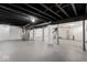 Large unfinished basement features painted walls, grey flooring, and duct work at 1429 Brookside Pkwy N Dr, Indianapolis, IN 46201