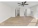 A roomy bedroom with wood-look floors, fresh white paint, and an open doorway to the bathroom at 1429 Brookside Pkwy N Dr, Indianapolis, IN 46201